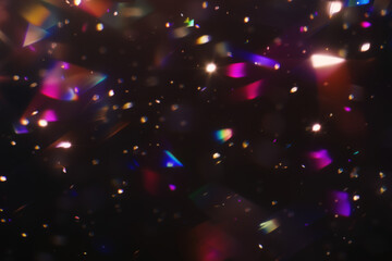 Colorful abstract light blurs with bokeh on dark background. Festive decoration, digital art, vibrant colors. Blurry sparkling particles in the air, festive light effect