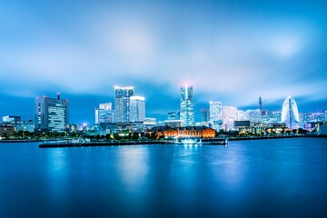 Yokohama skyline at night with illuminated skyscrapers.