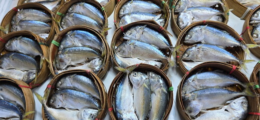 Steamed mackerel packed in round bamboo baskets in the market. Rastrelliger brachysoma is popular...