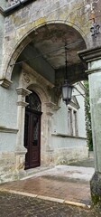 Historic stone archway entrance to an elegant building in a quaint town