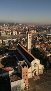drone aerial video of historical unesco heritage Italian Verona San Zeno church with chapel on piazza in sunny day 