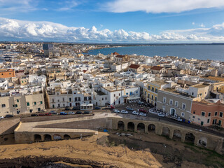 Fototapeta premium Aerial drone view of the coastal town named Gallipoli at the mediterranean sea in Italy.