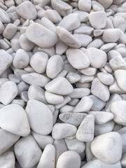 a white small pebbles stone as  background rock texture