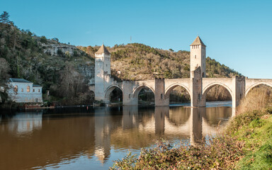 Fototapeta premium The 14th and 15th century Valentré bridge, a UNESCO World Heritage Site, crossing the Lot river in the town of Cahors in France