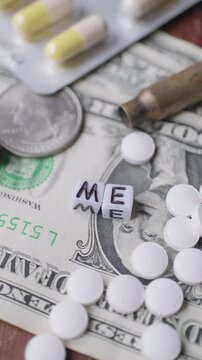 dollars in close-up bullet casings coins and writing cubes with ''ME'' in slow motion