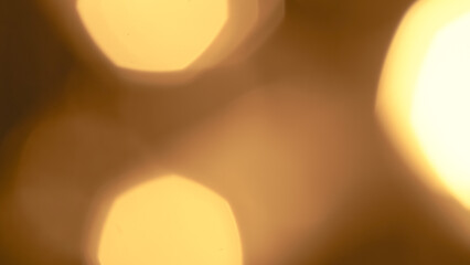 Soft golden bokeh background with glowing sparkles and a dreamy effect