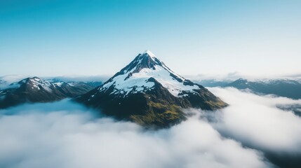 A mountain covered in snow and clouds