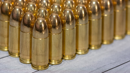 photo of a black pistol and bullets on a black background