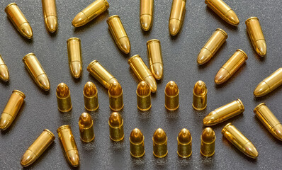 photo of a black pistol and bullets on a black background