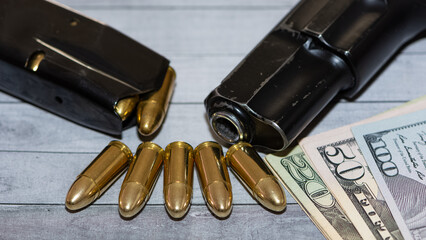 photo of a black pistol and bullets on a black background