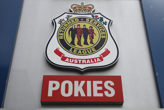 Returned Services League emblem, with red pokies sign beneath it, outside a RSL club