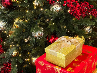 New Year background, postcard. Beautifully wrapped gifts on the background of a Christmas tree