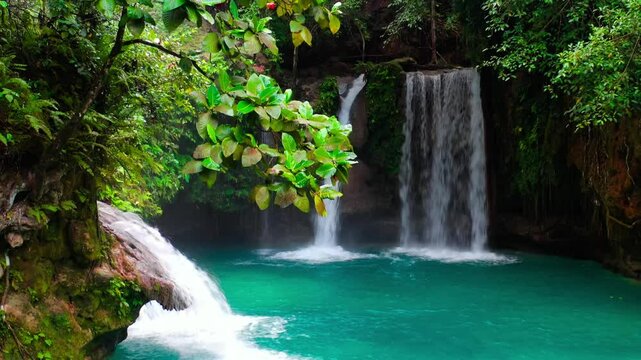 Aerial drone view Kawasan waterfalls in mountain gorge in the tropical jungle Philippines, Cebu. High quality 4k footage