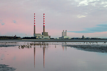 Poolbeg power station in Dublin, Ireland against a pinkish sky