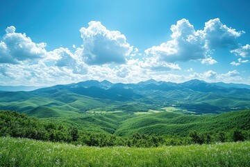 Obraz premium Green mountain landscape with lush vegetation under a cloudy blue sky
