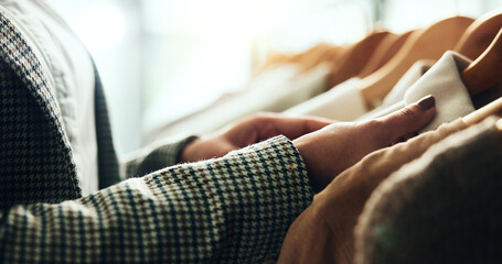 Fototapeta premium Shopping, retail and hands of woman with clothes on rack for sale, discount and store promotion. Fashion, boutique and customer with choice, decision and option for textile, fabric and clothing