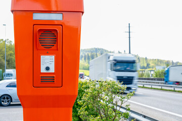 Call box on the roadside of a Swiss highway. Instructions in several languages. Can be used in case of emergency to get help.