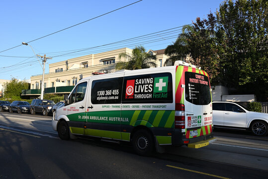 A St John Ambulance Australia complex patient transport vehicle, a Mercedes Benz Sprinter, traveling through the suburbs of Melbourne