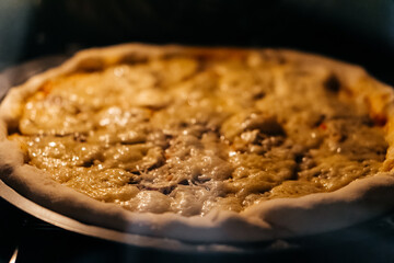 baking making pizza with cheese in an electric oven