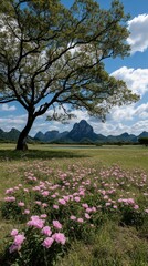 Obraz premium Pink Peony Field with Lone Tree and Mountain View under Blue Sky