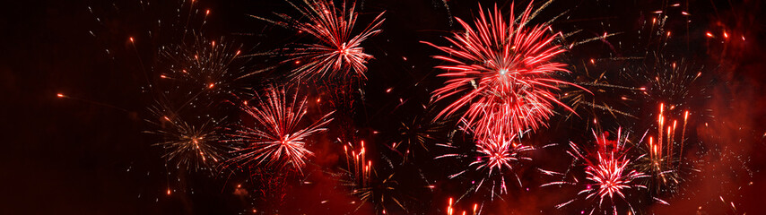 Fototapeta premium happy new year, new year's eve, silvester, new year, festival, greeting card, new year card long panorama - red fireworks firework pyrotechnic pyrotechnics, on black night sky background