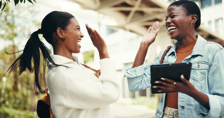 Student, tablet and high five friend at university for scholarship success, exam results and good news. Excited, people and celebration on campus for assignment grade or achievement on college portal