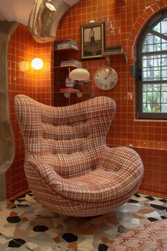 Orange Tiled Room Featuring Swivel Egg Chair