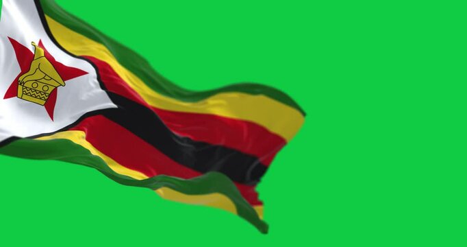 Close-up view of the Zimbabwe national flag waving isolated on green background