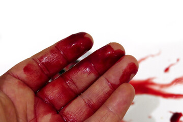 Blood flows into the sink from the hand of a person whose hand was injured with a knife