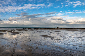 December blue sky with dappled clouds on Cornish beach