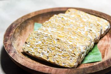 Raw tempeh, cut into pieces, made from soybeans, a traditional indonesian food.