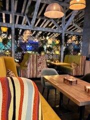 Multi-colored sofa in the dark interior of an Uzbek restaurant
