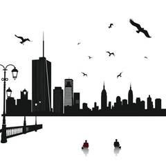 Silhouette of a city skyline with two people sitting by the water.