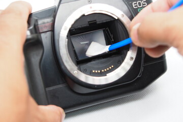 Camera Technician Expertly Cleans Sensor for Optimal Photography Equipment Performance
