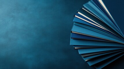 Books are carefully arranged in a fan shape, showcasing rich blue covers against a muted backdrop. The soft lighting casts a calming atmosphere, inviting exploration and thought