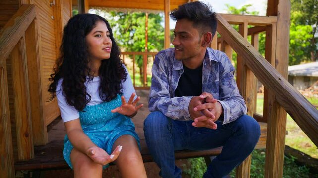 Young Couple Conversing on Wooden Steps
