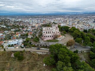 Fototapeta premium King Zog Villa with classical architecture under a cloudy sky in a scenic location in Durres, Albania, an aerial drone photo