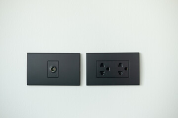 Black electrical outlet and inserts the antenna cable to the TV outlet. Element of modern interior...