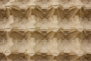 The texture of the cardboard of the egg carton. Close up.
