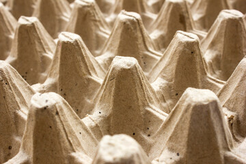 Empty biodegradable molded egg box made of paper pulp, close up view, background and texture.