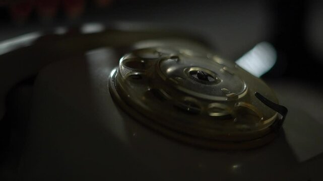 White analog old corded telephone in dark room