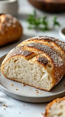 A freshly sliced loaf of artisanal bread on a plate, showcasing its crust and texture.