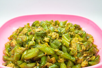 Stir-fried green beans mixed with chicken eggs served on a plate. isolated on white background