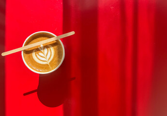Hot coffee latte on red background