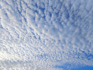 Defocused view of white clouds on the blue sky