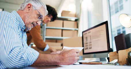 Senior, man and reading documents for distribution industry, inventory update and logistics information. People, computer and ecommerce paperwork with stock checklist, startup admin and order report