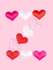Letter Z made of glossy atlas hearts isolated on solid pink background. Love alphabet concept. One letter of the set of heart's font easy to stacking.