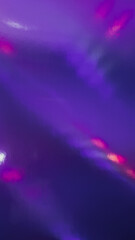 top shot of abstract pastel iridescent holographic foil background with light leaks. holo purple holo flat foil material. cool glitter surface with shiny rainbow feel. 