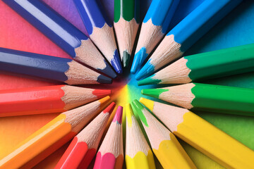 Sharply pointed colored pencils in a vibrant gradient, enhancing artistic presentation