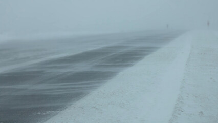 Winter snow road at blizzard